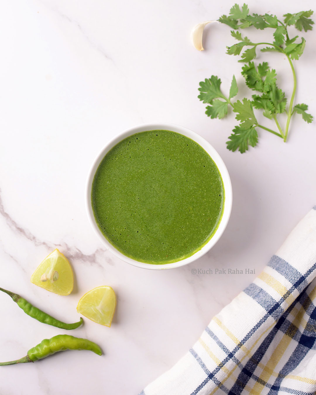 Cilantro Mint Chutney served in white bowl.