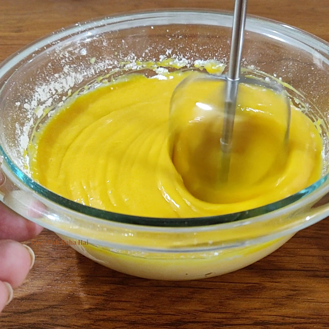 Mixing mango pulp, condensed milk & sugar.