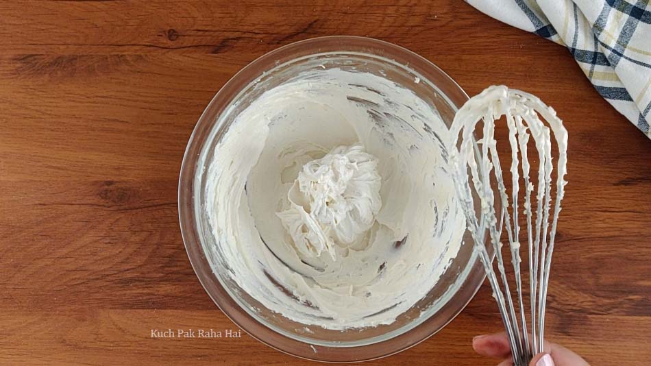 Whisking butter & sugar in a bowl.