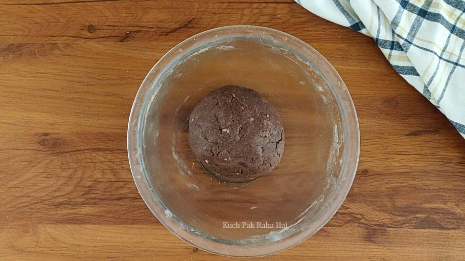 Making chocolate cookie dough in a bowl.