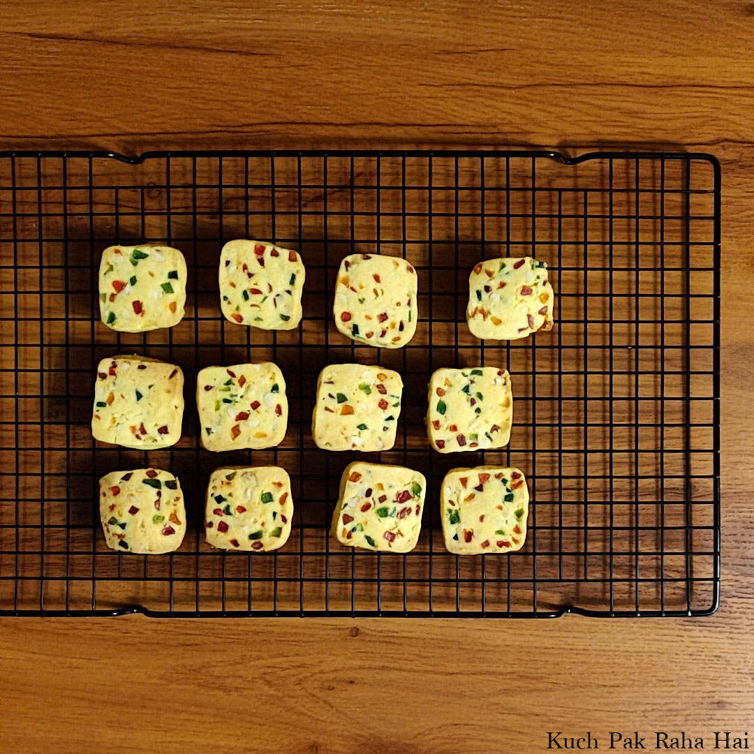 Tutti frutti cookies cooking down on wire rack.