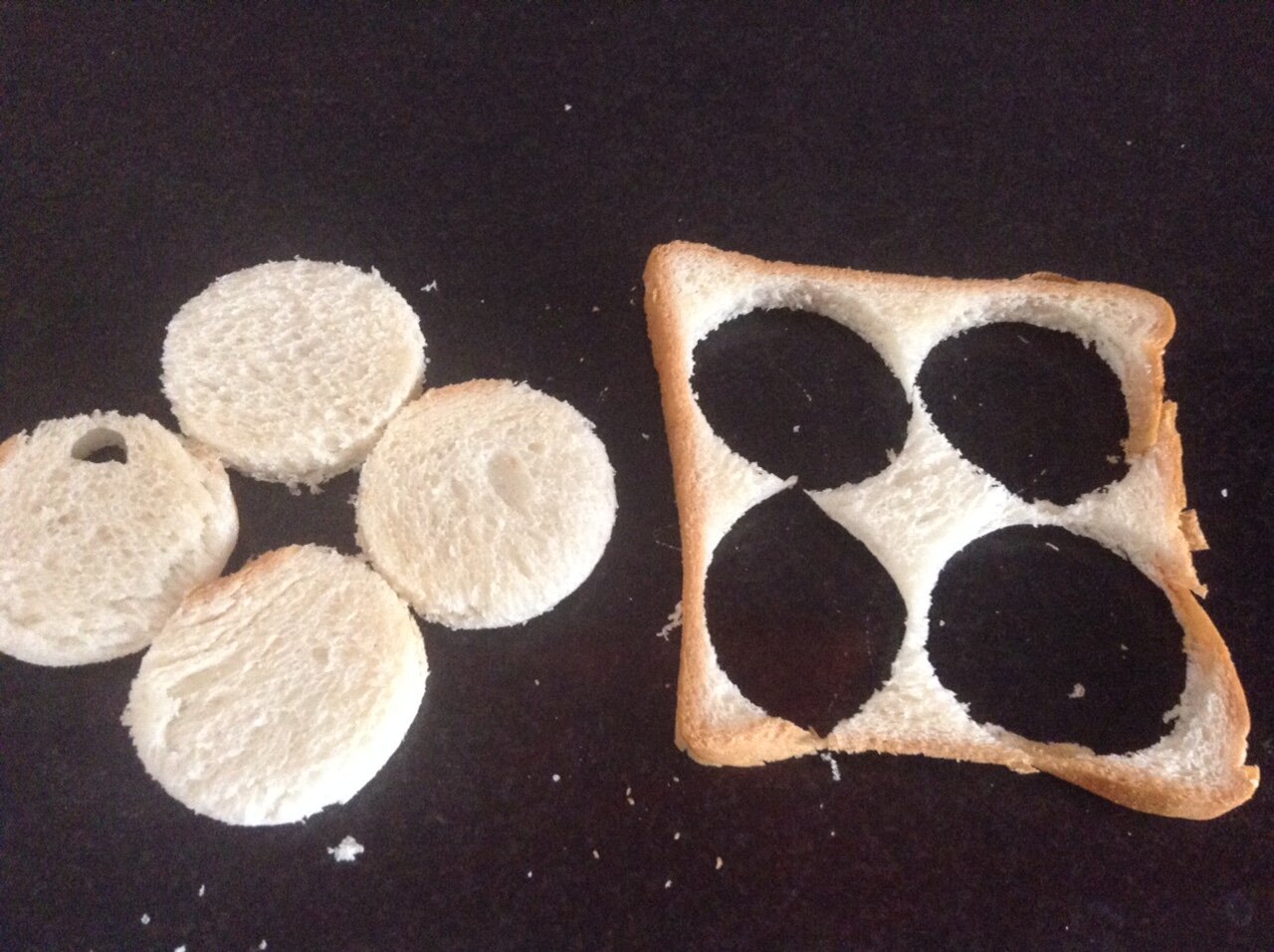 Cutting round circles from bread slice to make canapes.