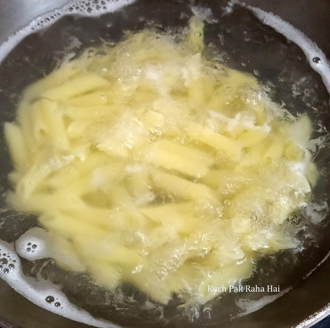 Boiling penne pasta.