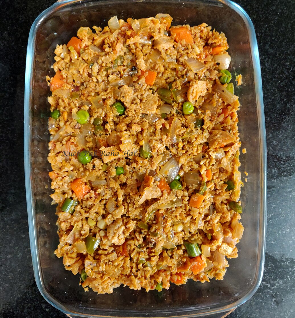 Layer of vegan soy mince in baking dish.