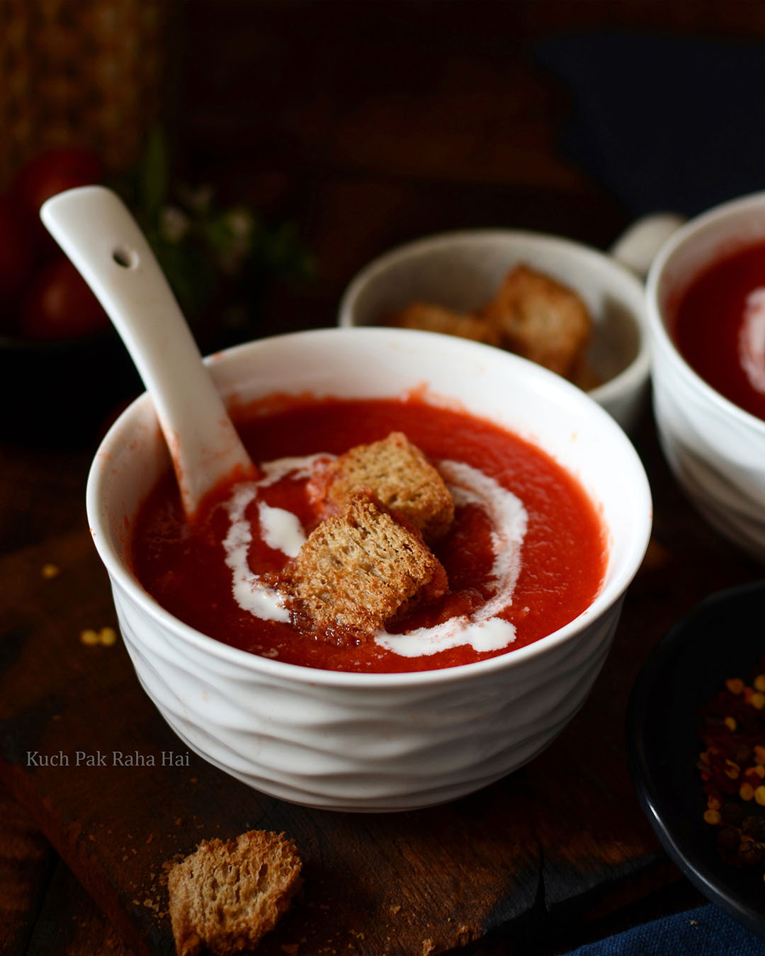 Tomato soup served with bread croutons.