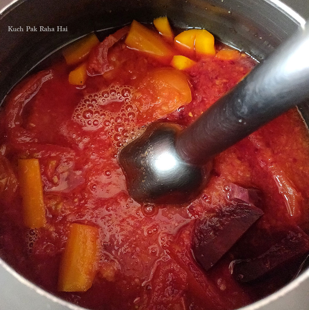 Blending soup with immersion blender.