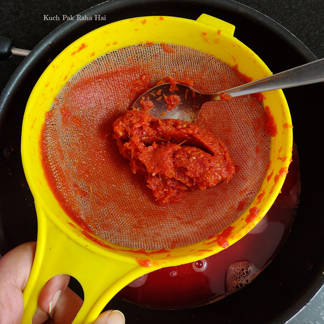 Tomato seeds and peel left  behind in sieve.