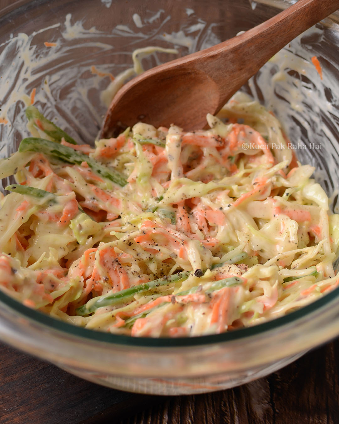 Coleslaw salad made with cabbage, carrots, bell peppers.