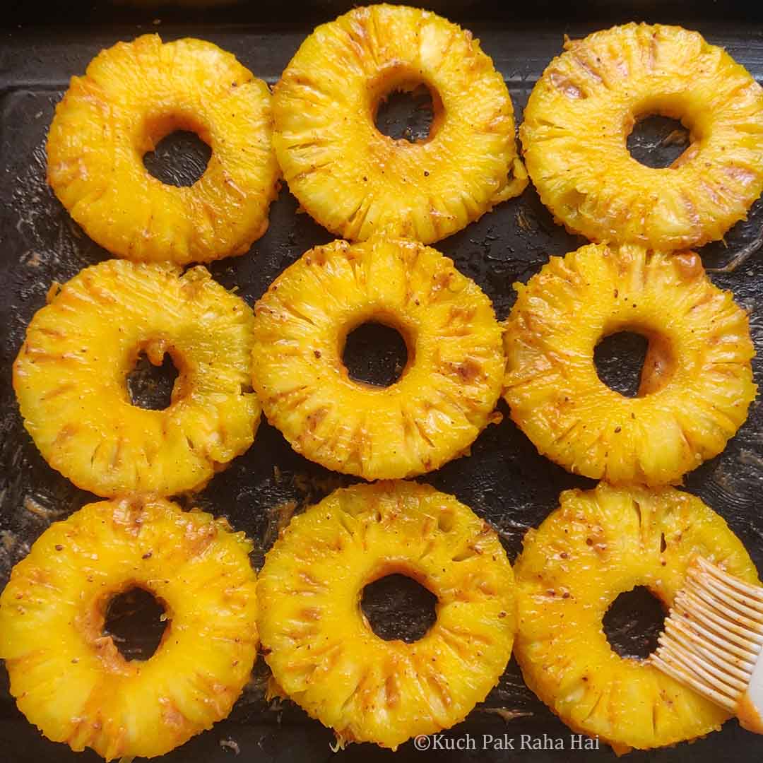 Marinating pineapple rings.
