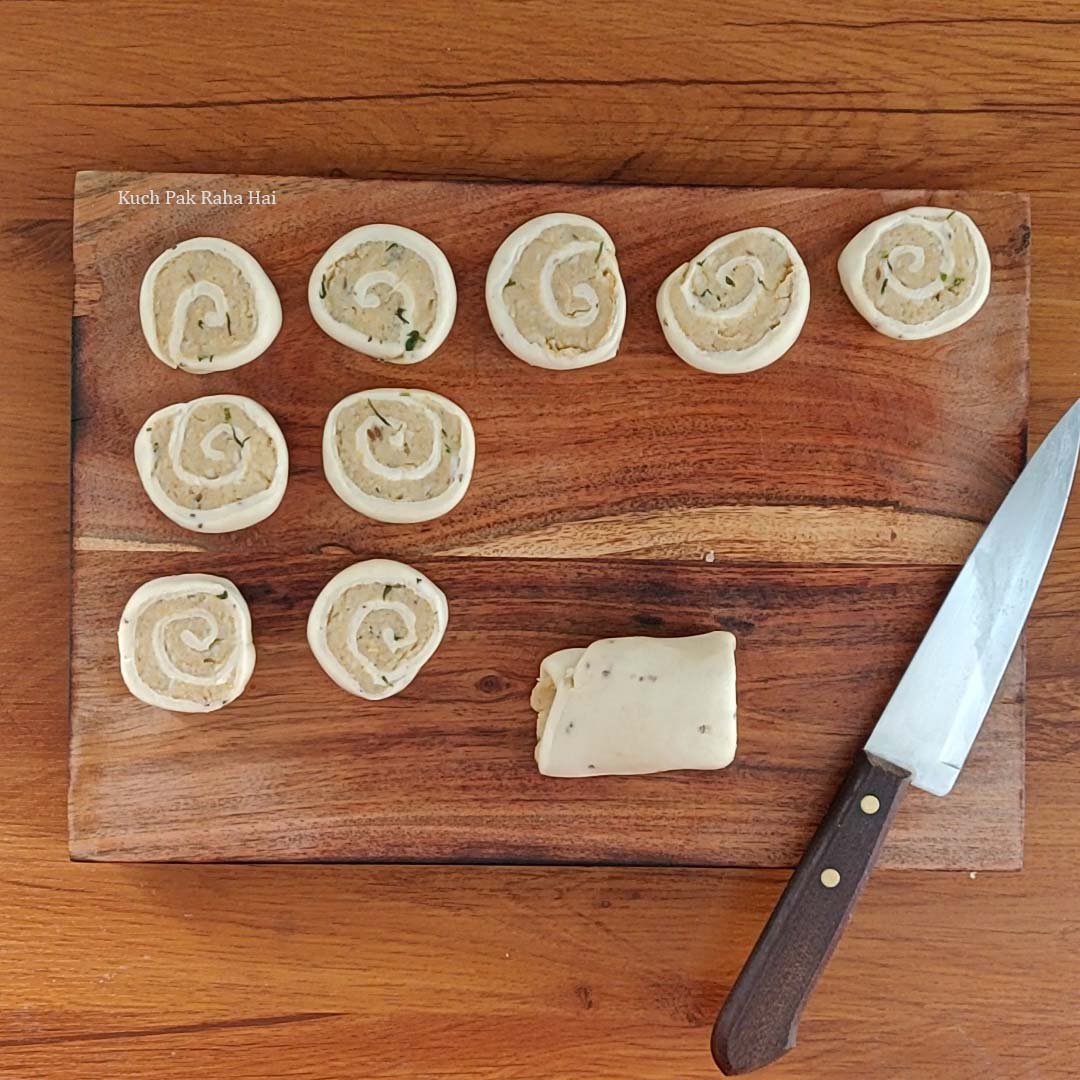 Cutting pinwheels using sharp knife.