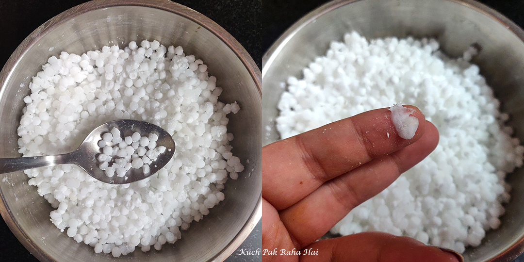 Pressing sabudana to check if it has softened.