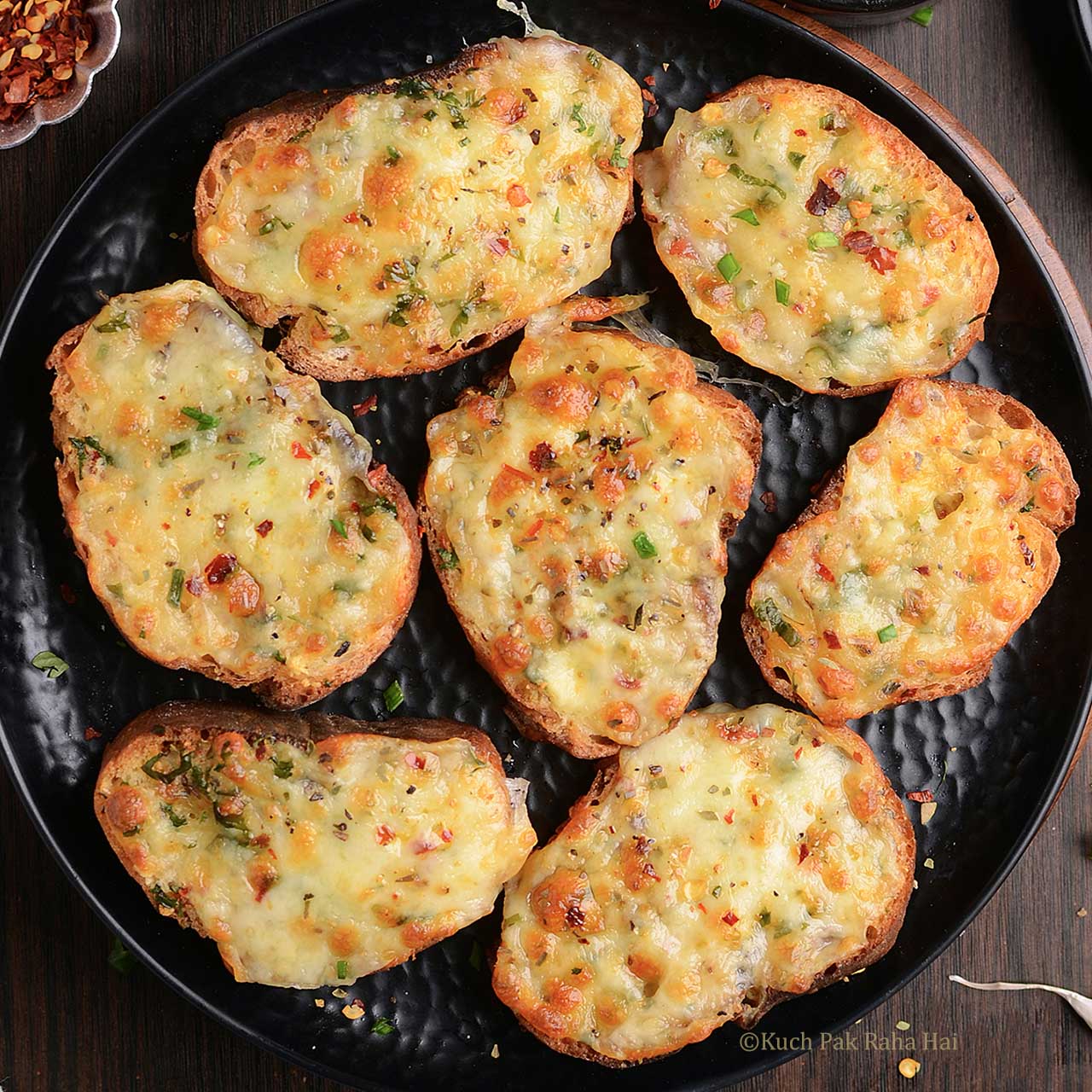 Cheese Garlic bread made in air fryer served on black plate.