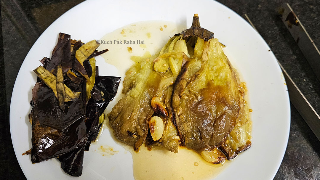 Peeling eggplant with help of kitchen tongs.