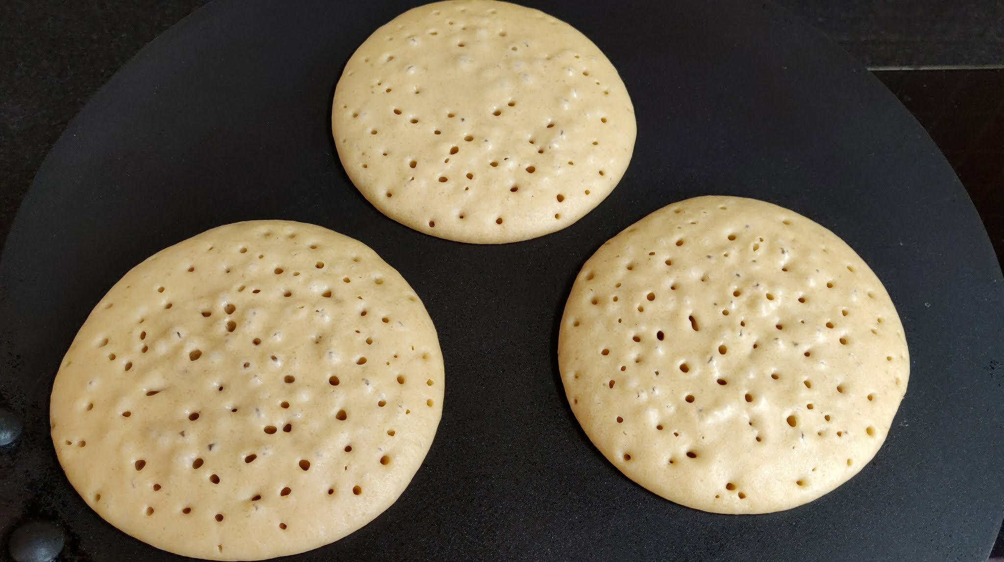 Banana Pancakes cooking from one side.