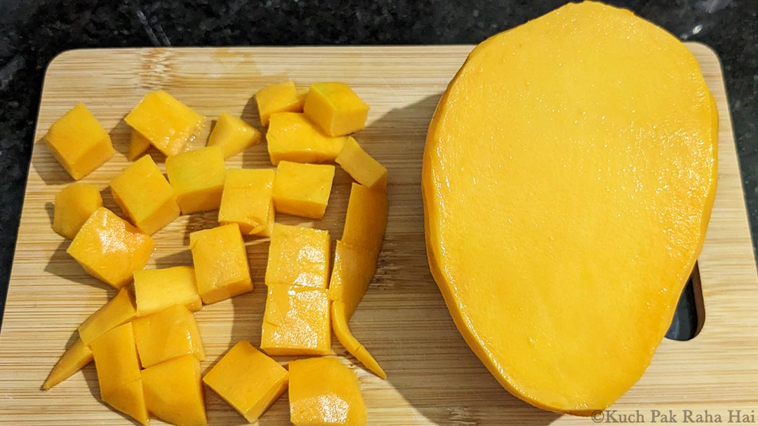 Chopping mangoes for lemonade.