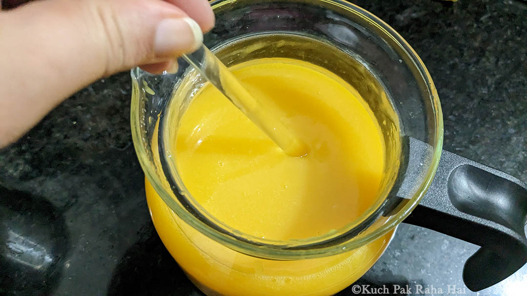 Stirring Mango Lemonade with stirrer.