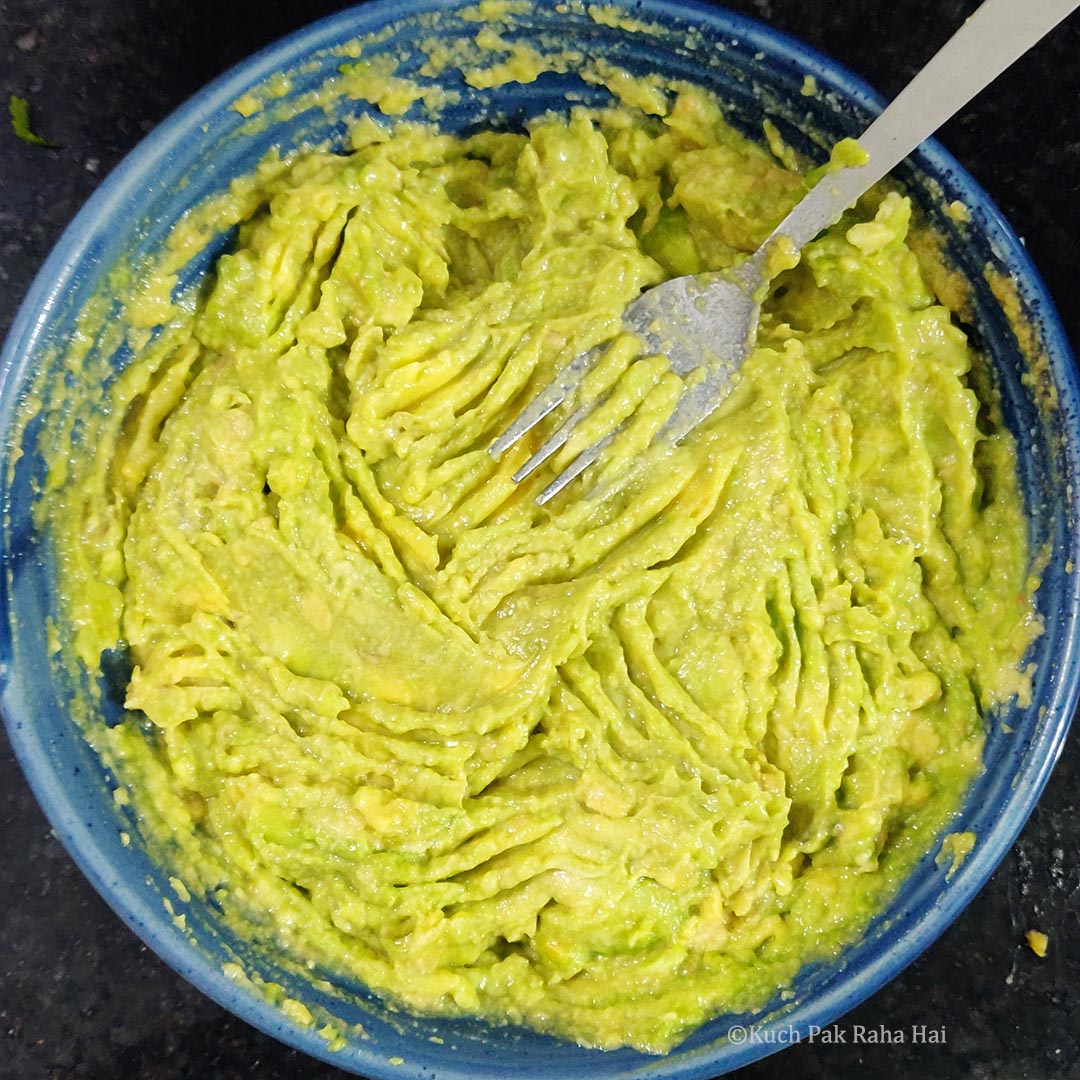 Mashing avocados.
