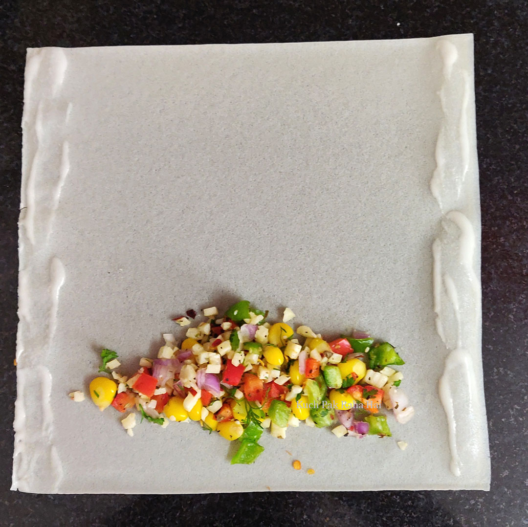 Cheese filling placed on spring roll sheet.