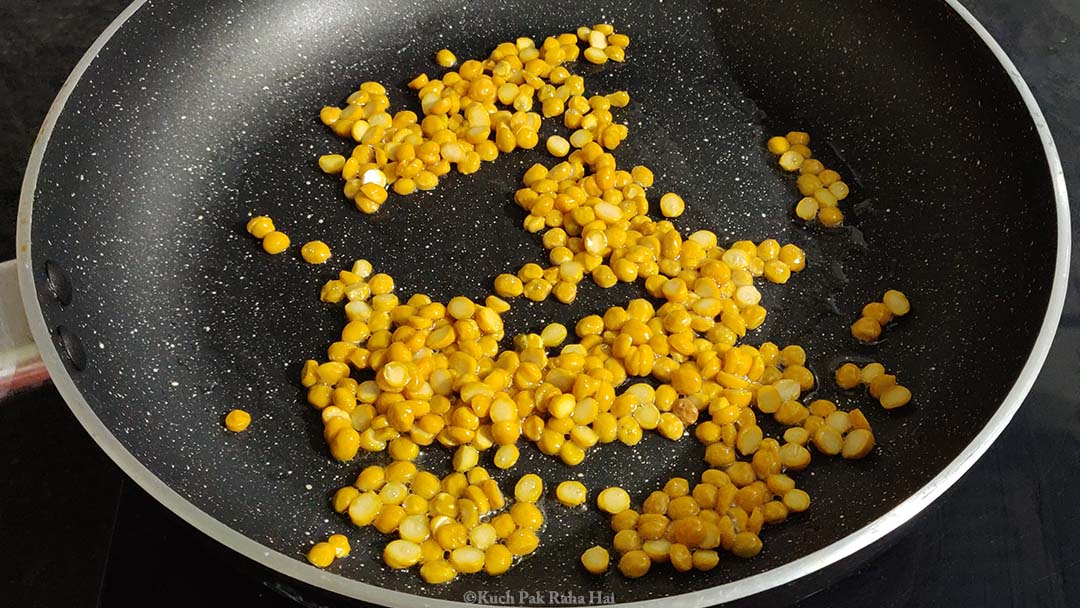 Roasting chana dal in pan.