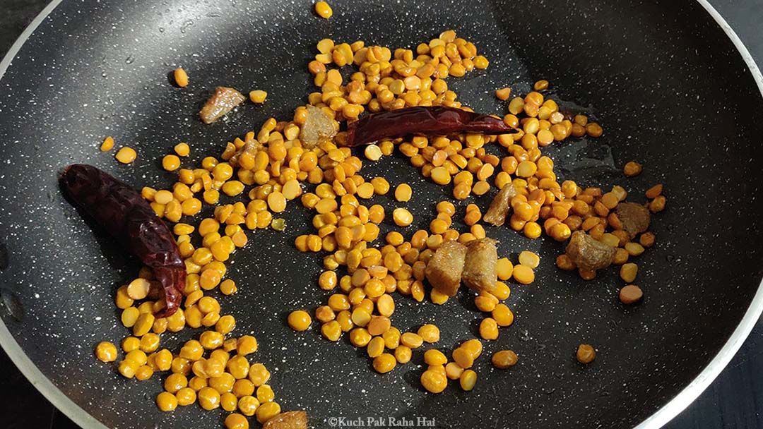Roasting ginger, dried chillies with chana dal.