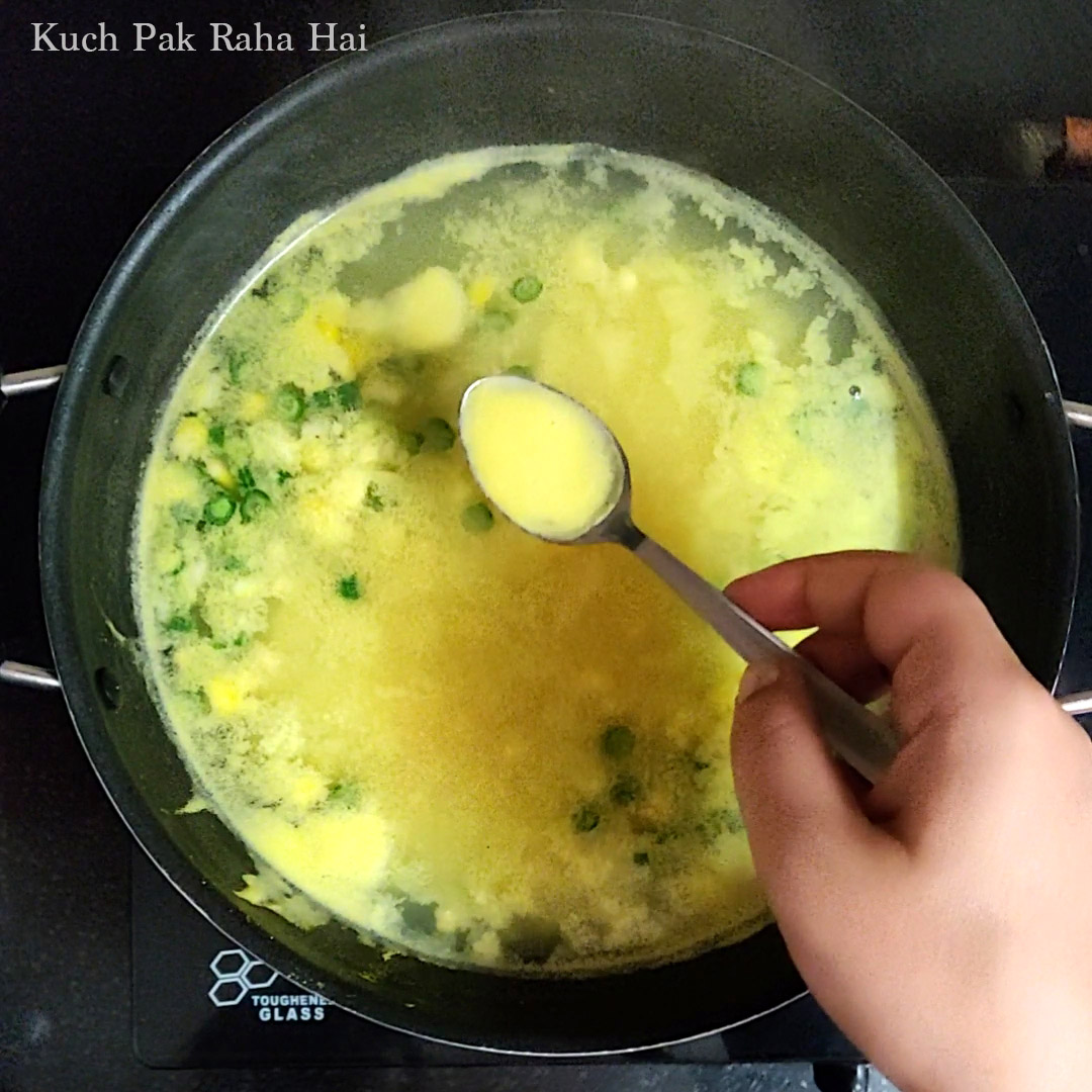 Removing foam from top of soup.