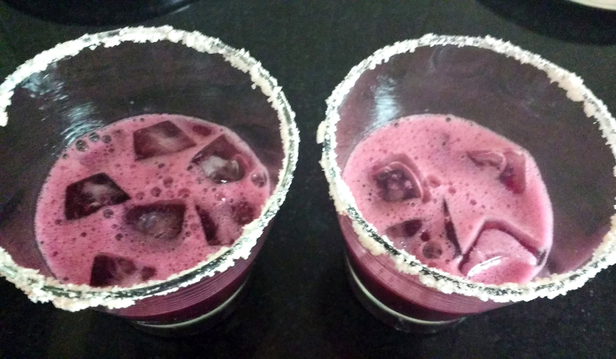 Pouring grape juice in serving glasses.