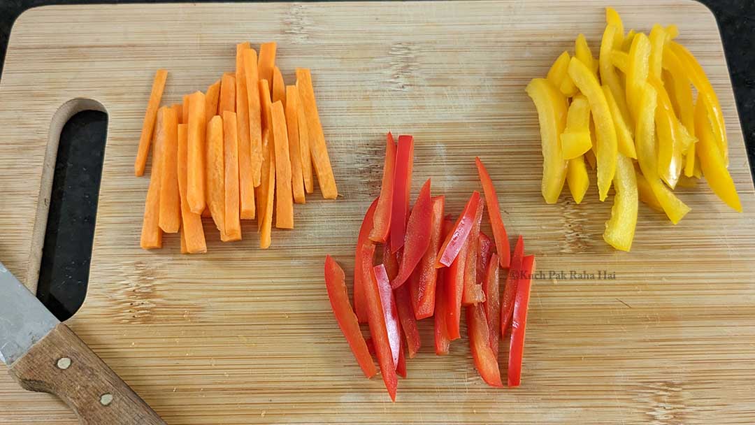 Chopping carrots bell peppers.