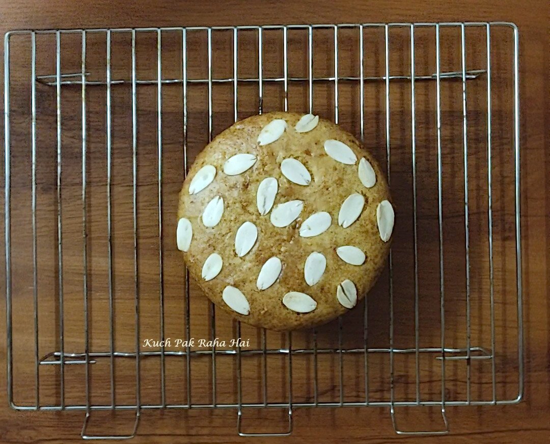 Mango cake cooling on wire rack.