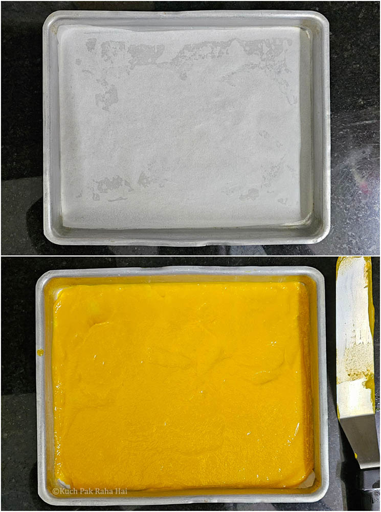 Spreading mango puree on baking tray.