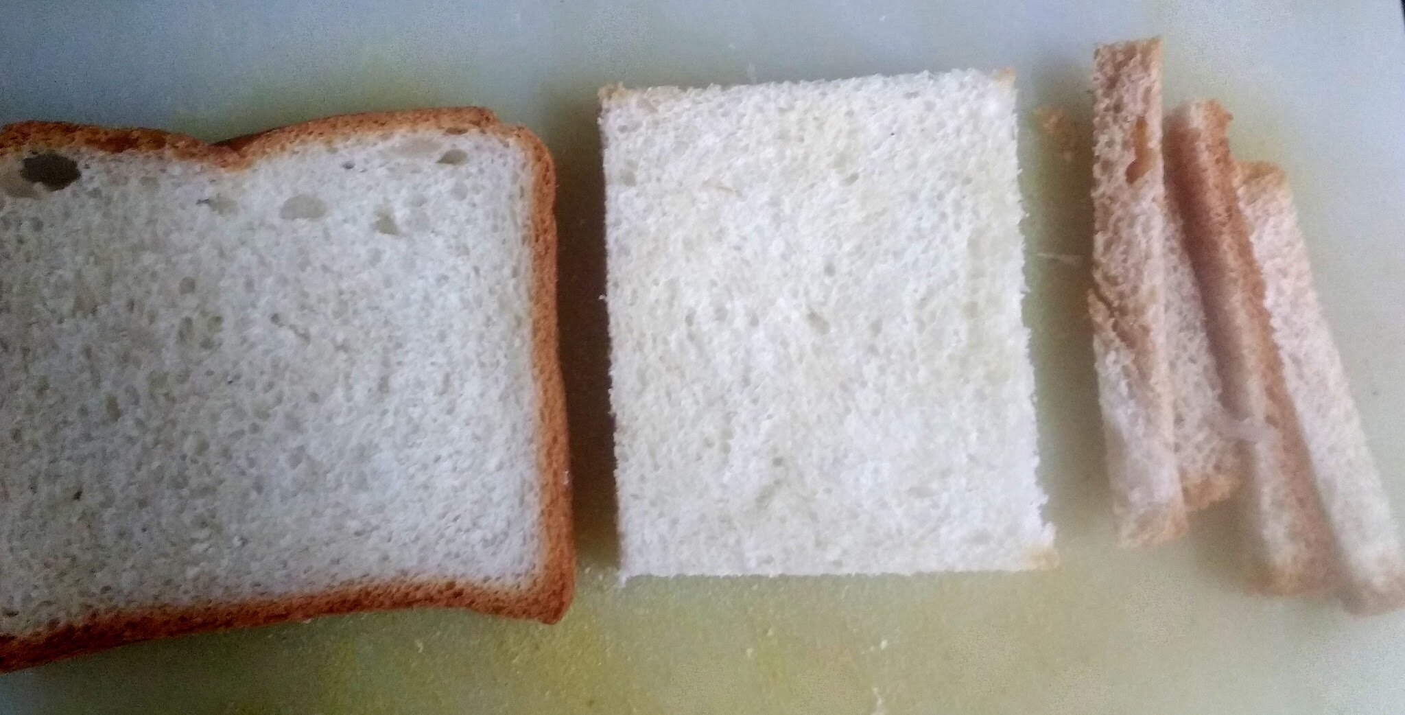 Bread slices on chopping board.