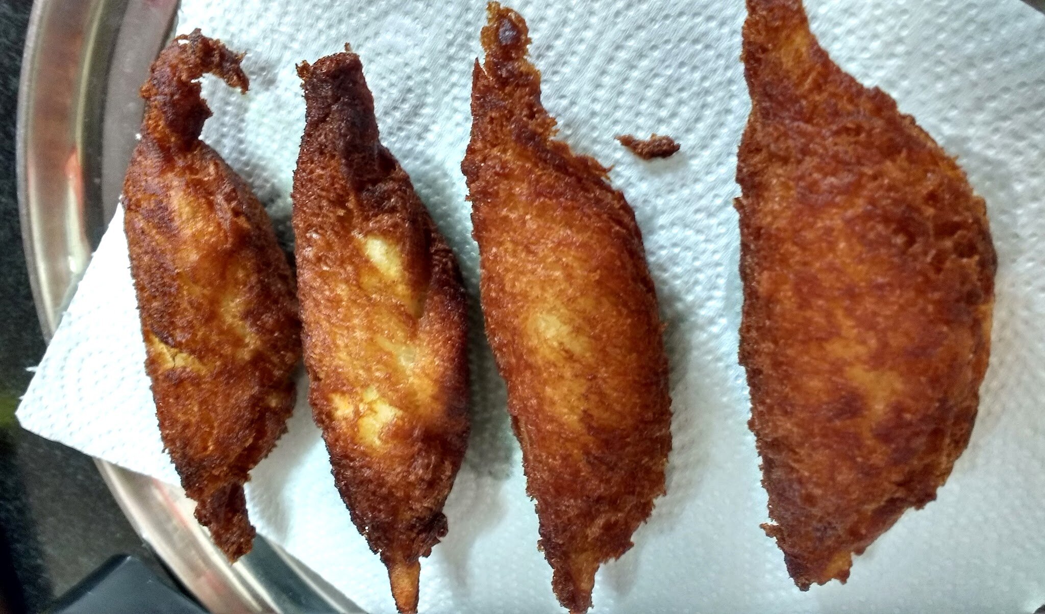 Fried dahi ke sholey on kitchen tissue.