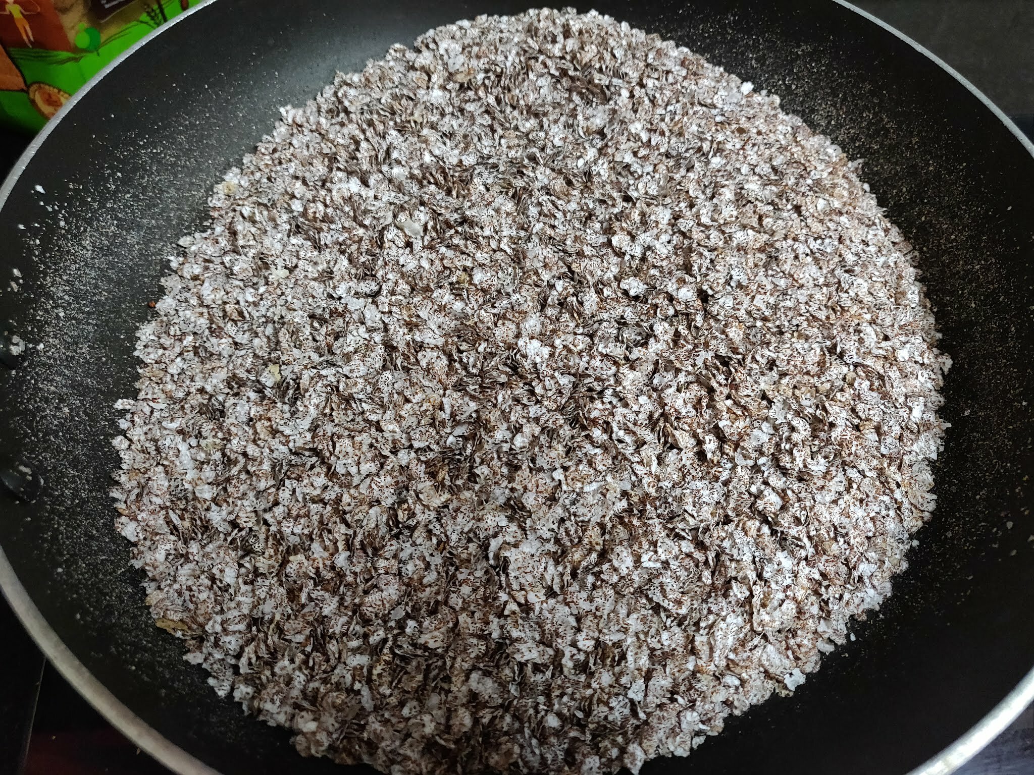 Roasting ragi flakes.