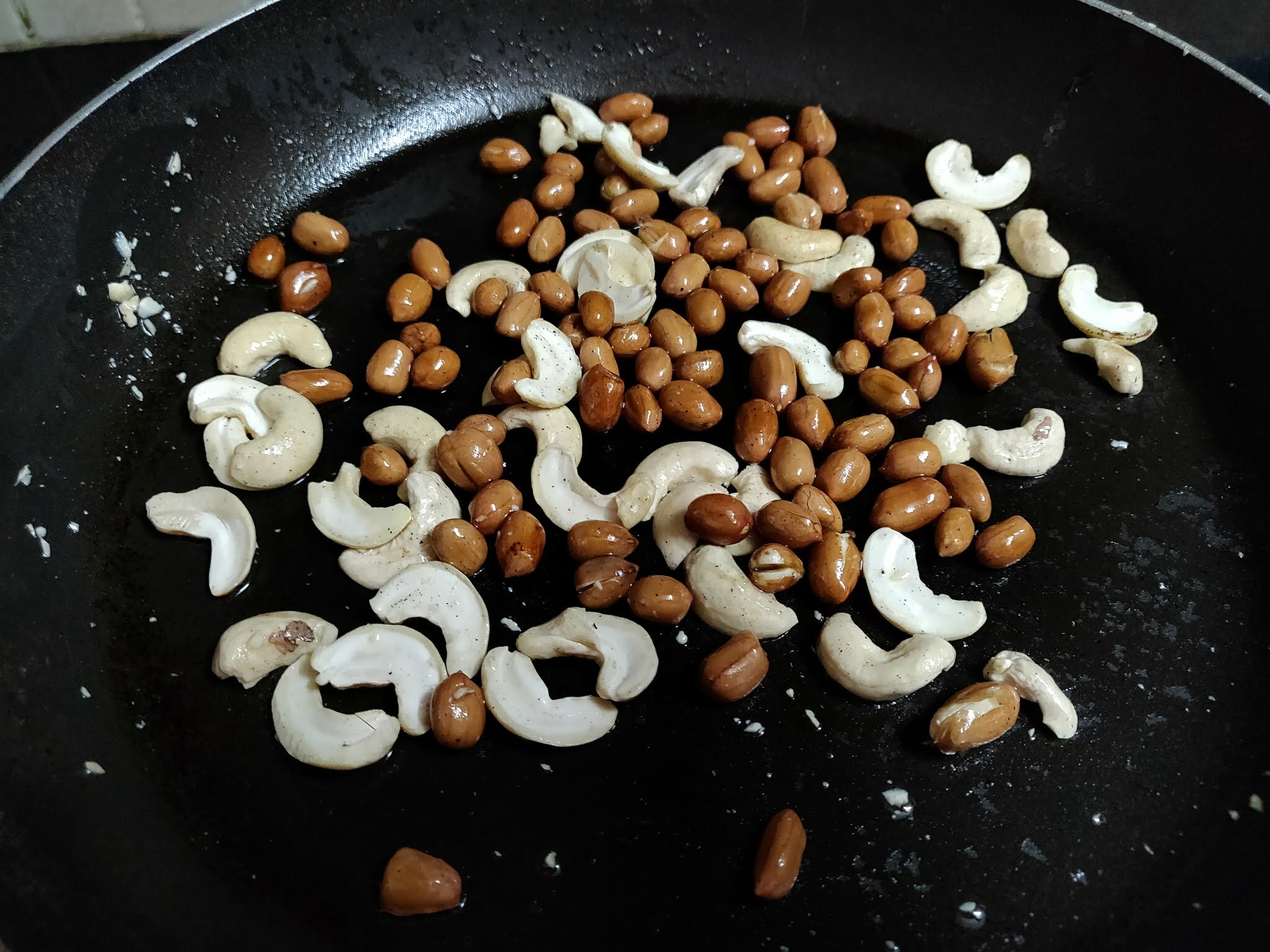 Roasting nuts in pan.