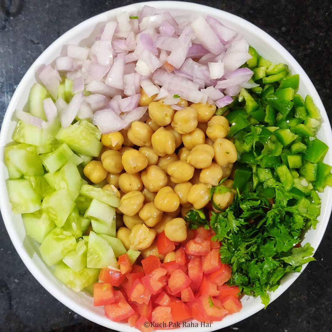 Mixing chickpea salad ingredients in a bowl.