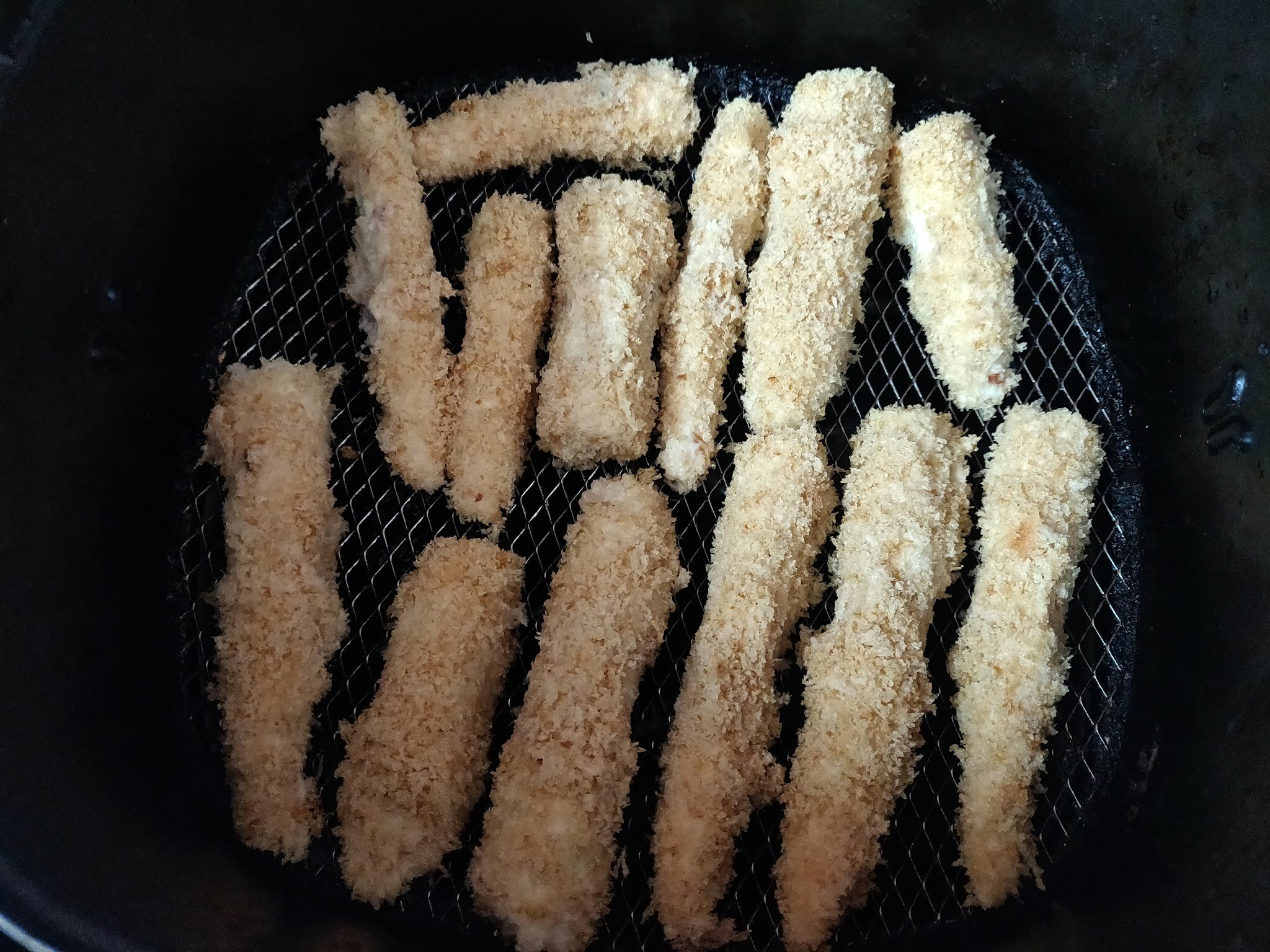 Baby corns in air fryer basket.