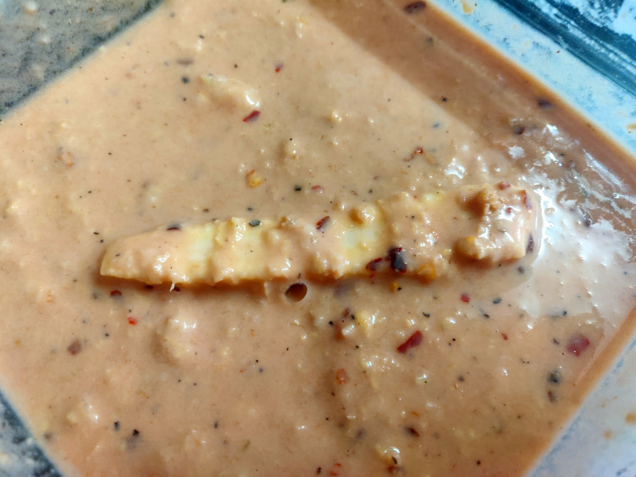 Dipping baby corn in batter first.