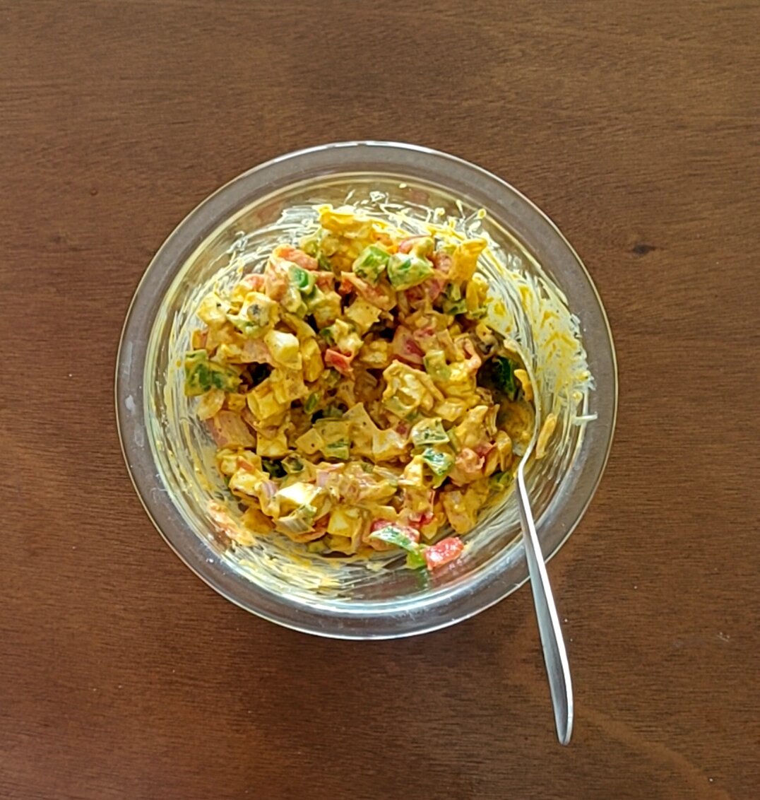 Mixing tandoori mayonnaise with vegetables and paneer.