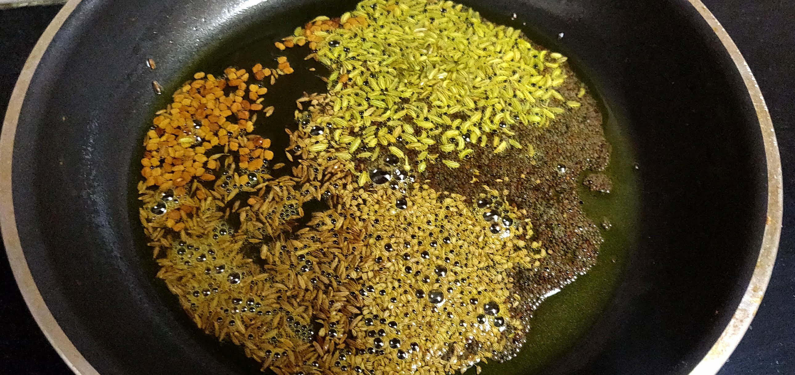 Sautéing whole spices.