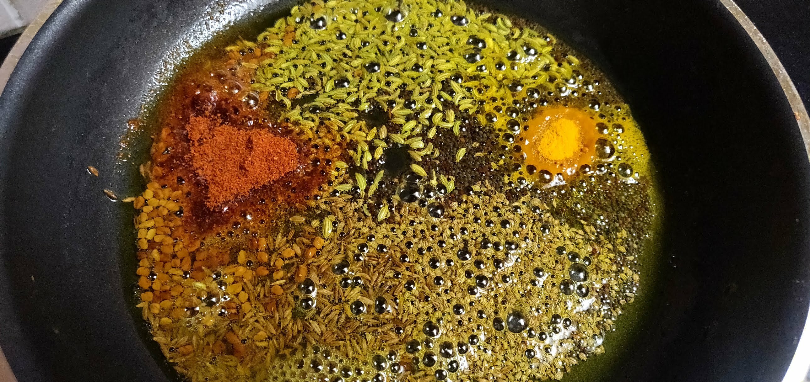 Roasting powdered spices.