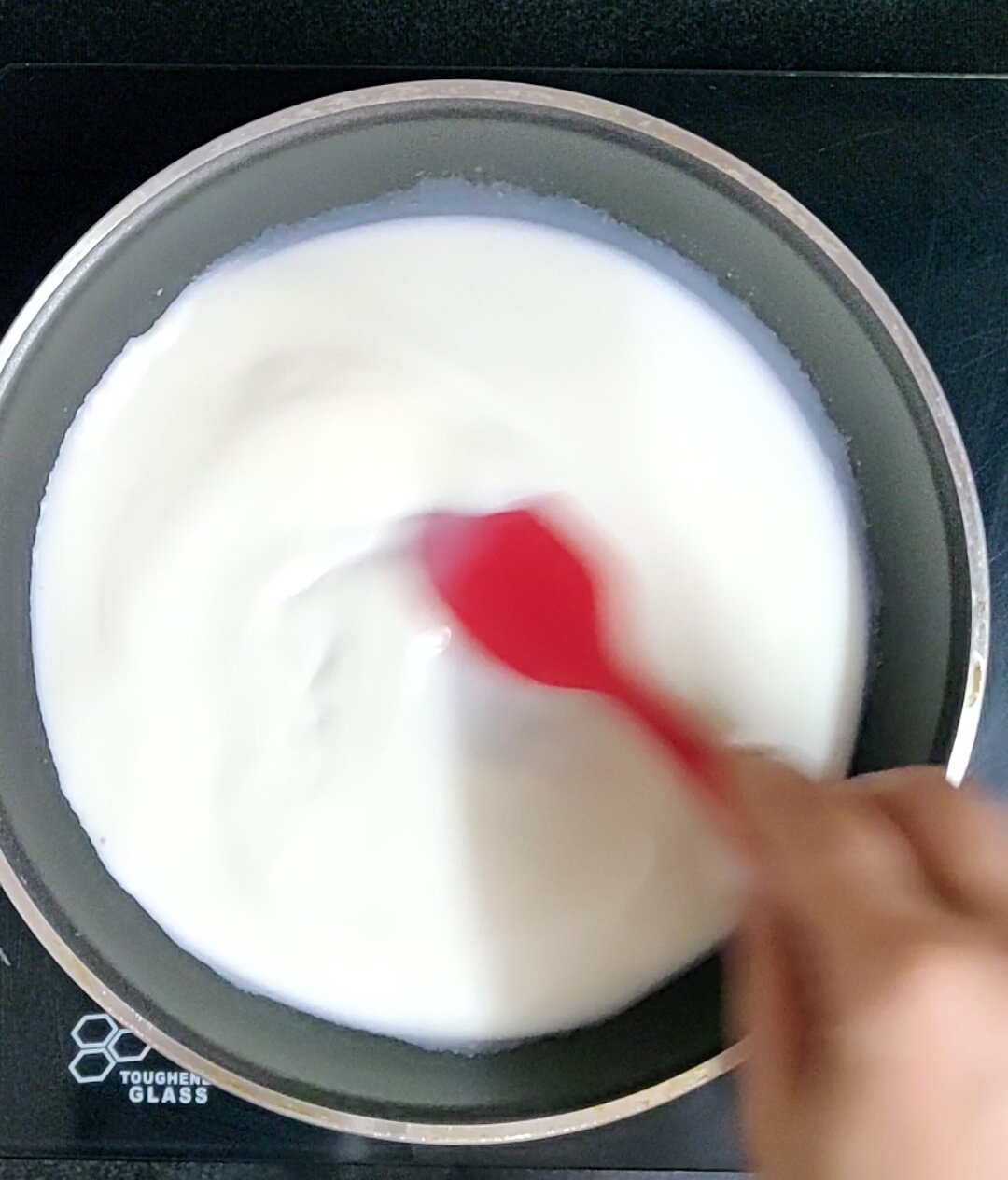 Heating milk & agar agar in pan.