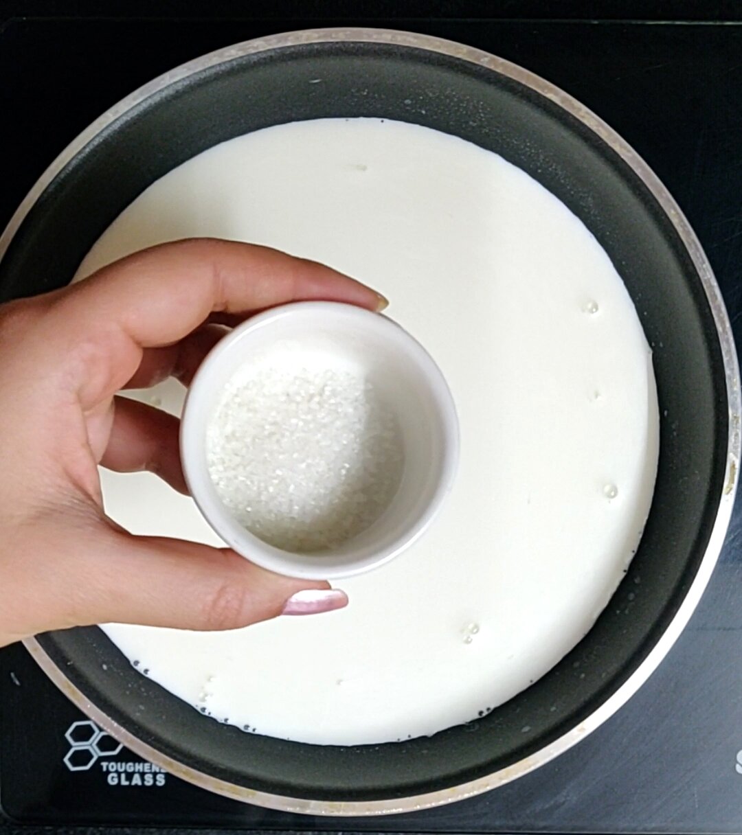 Adding sugar to milk & cream mixture.