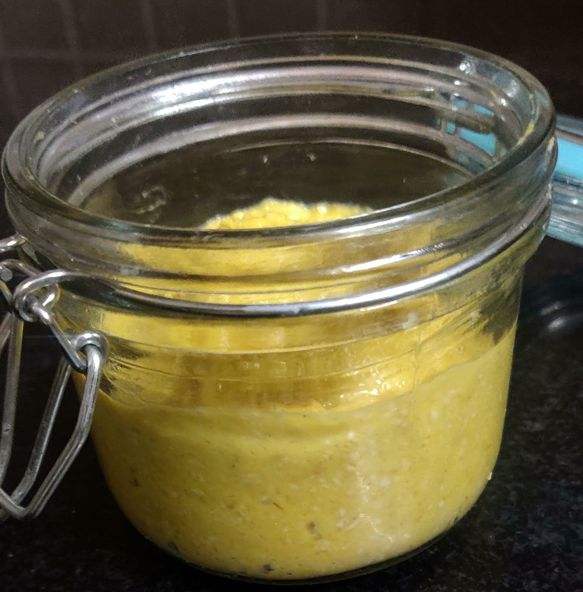 Transferring mango oats mixture in a jar.