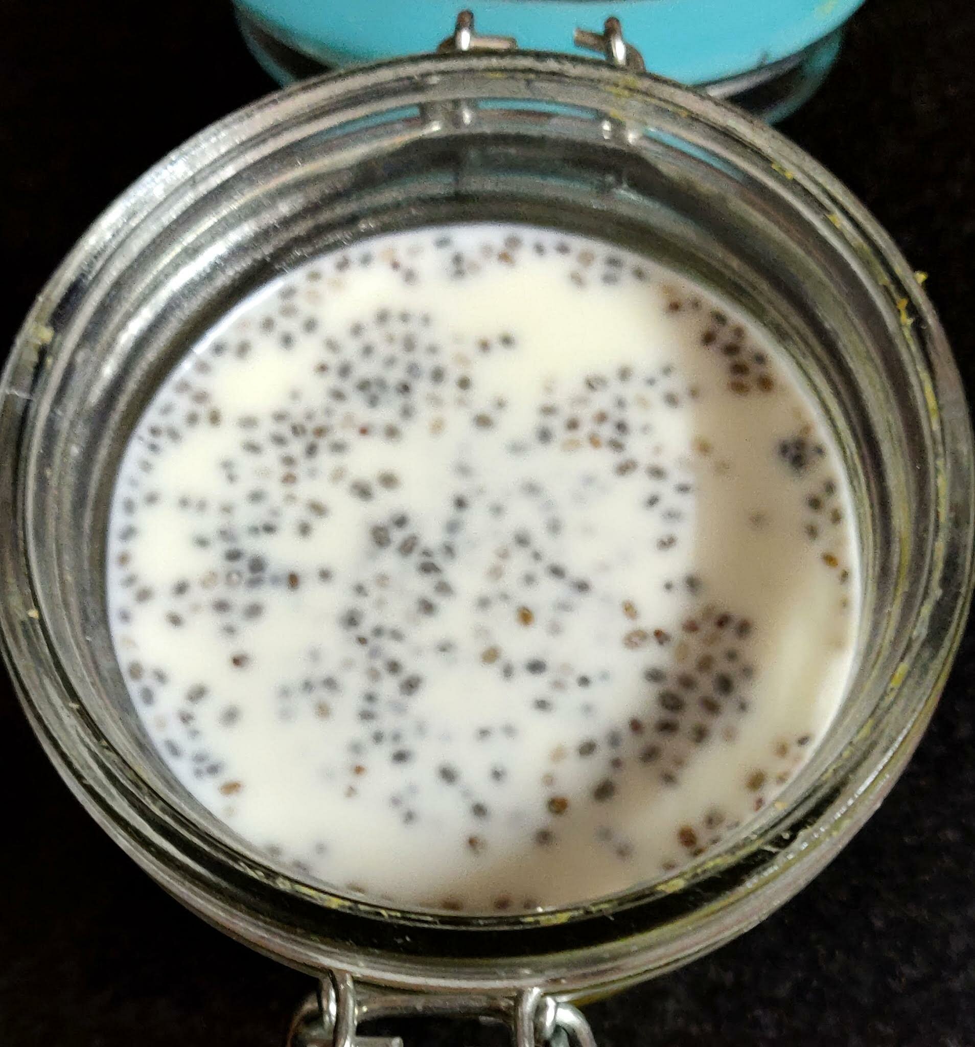 Pouring chia seed pudding layer over mango oats.