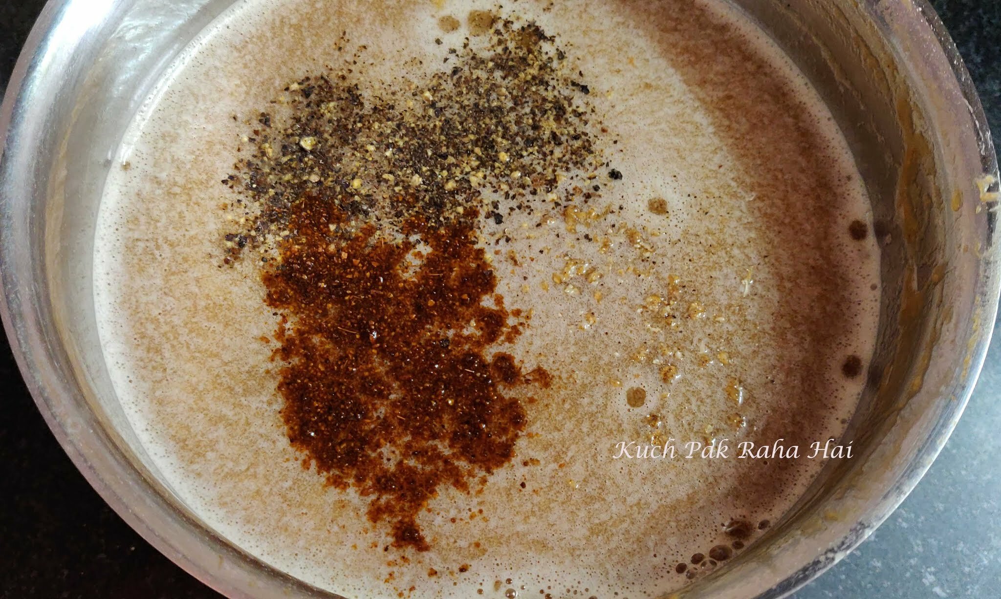 Adding spices to imli panna.