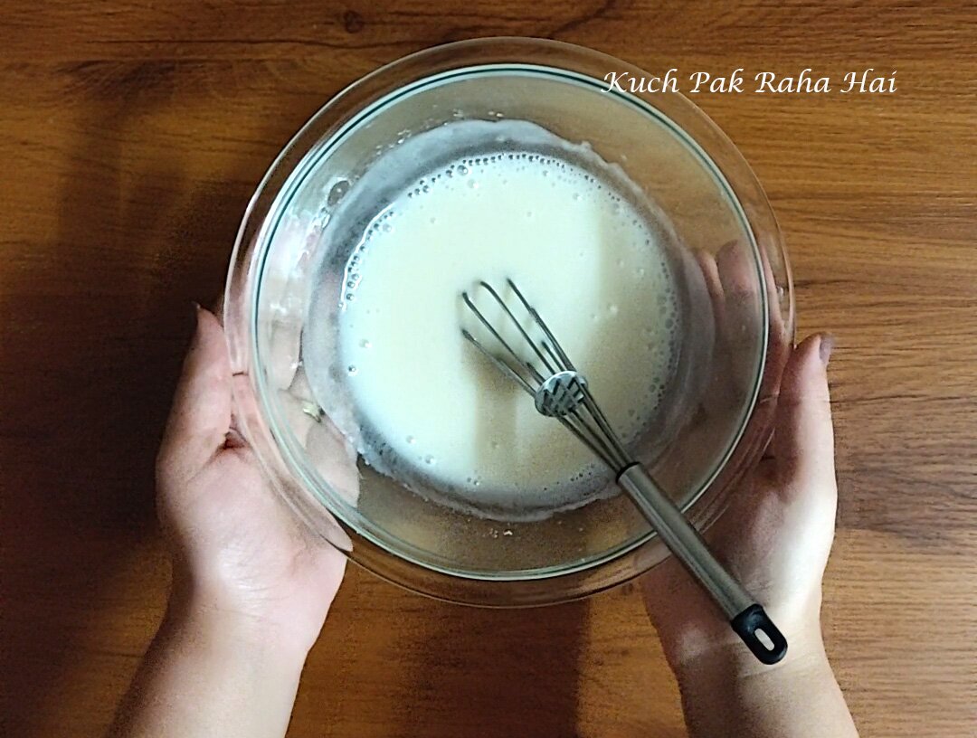 Whisking wet ingredients in a bowl.