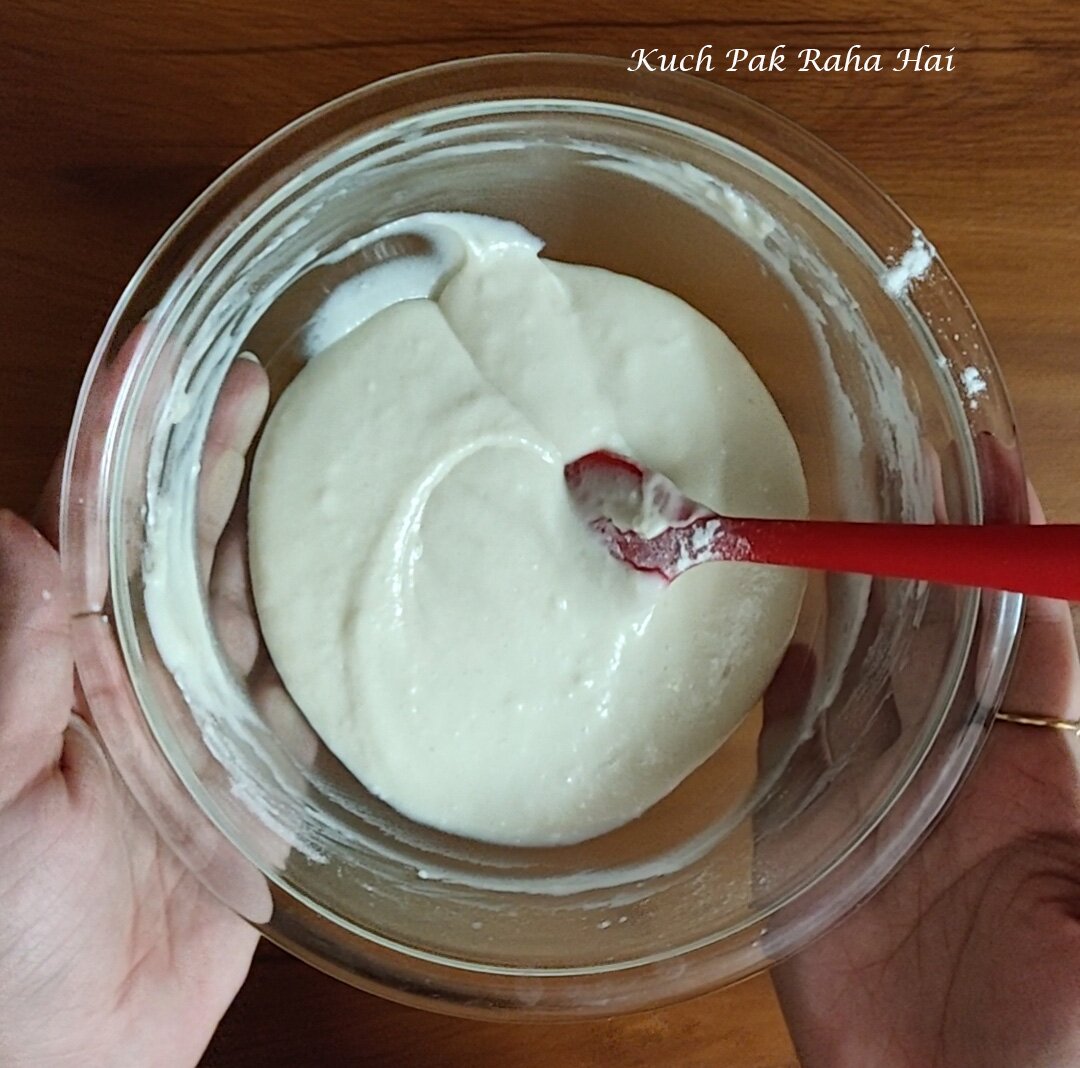 Folding dry ingredients into wet ingredients to make cupcake batter.