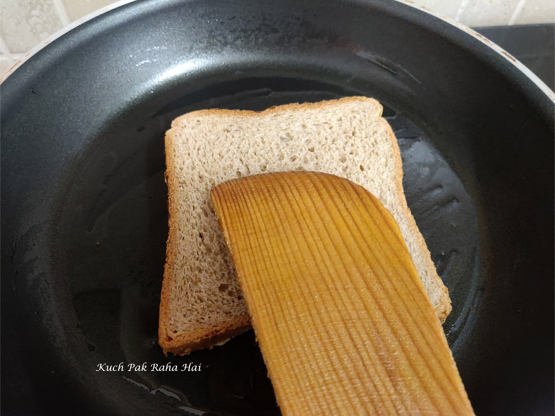 Cooking moong dal or lentil toast in a pan.