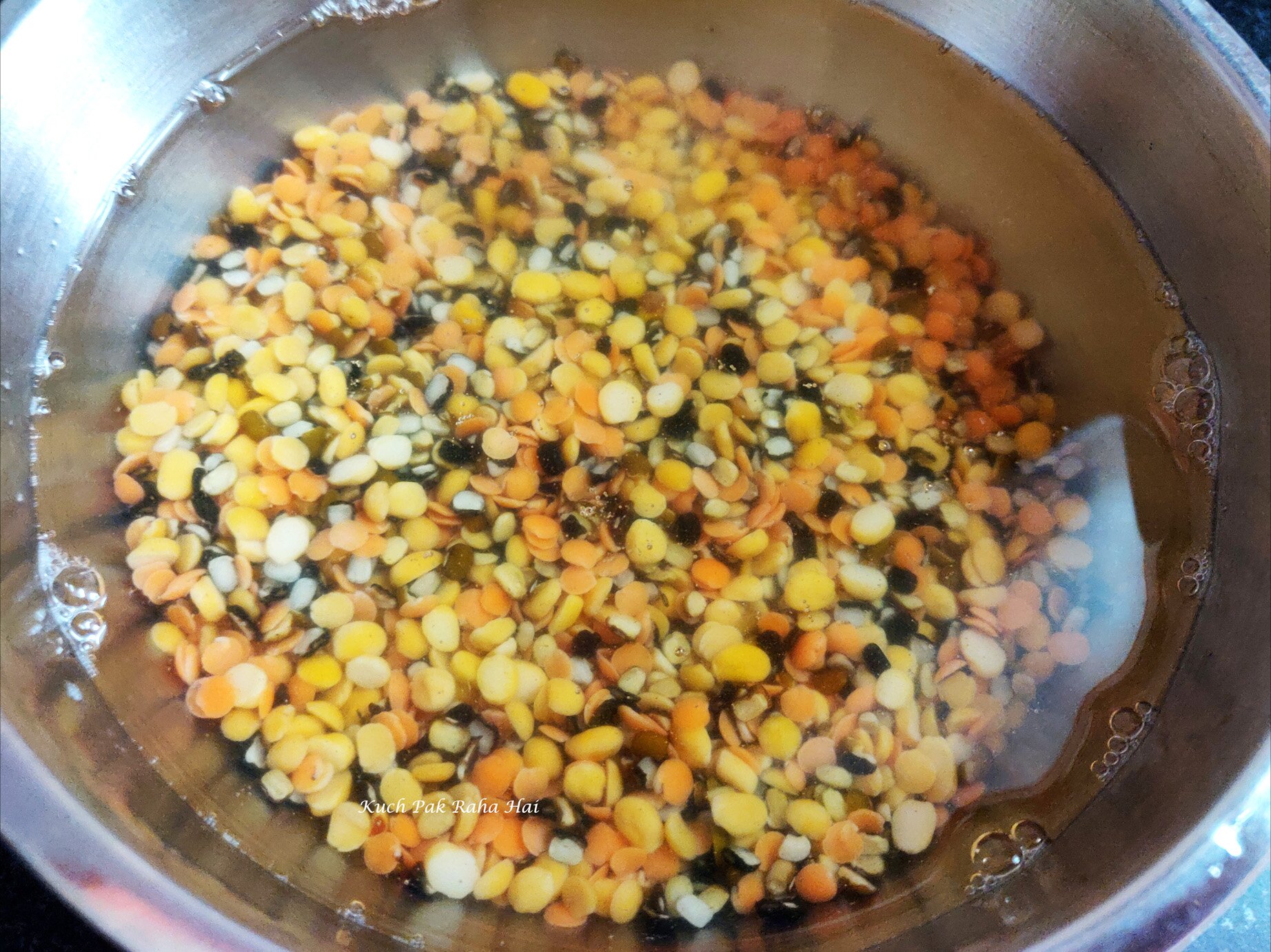 Soaking lentils in water before cooking.