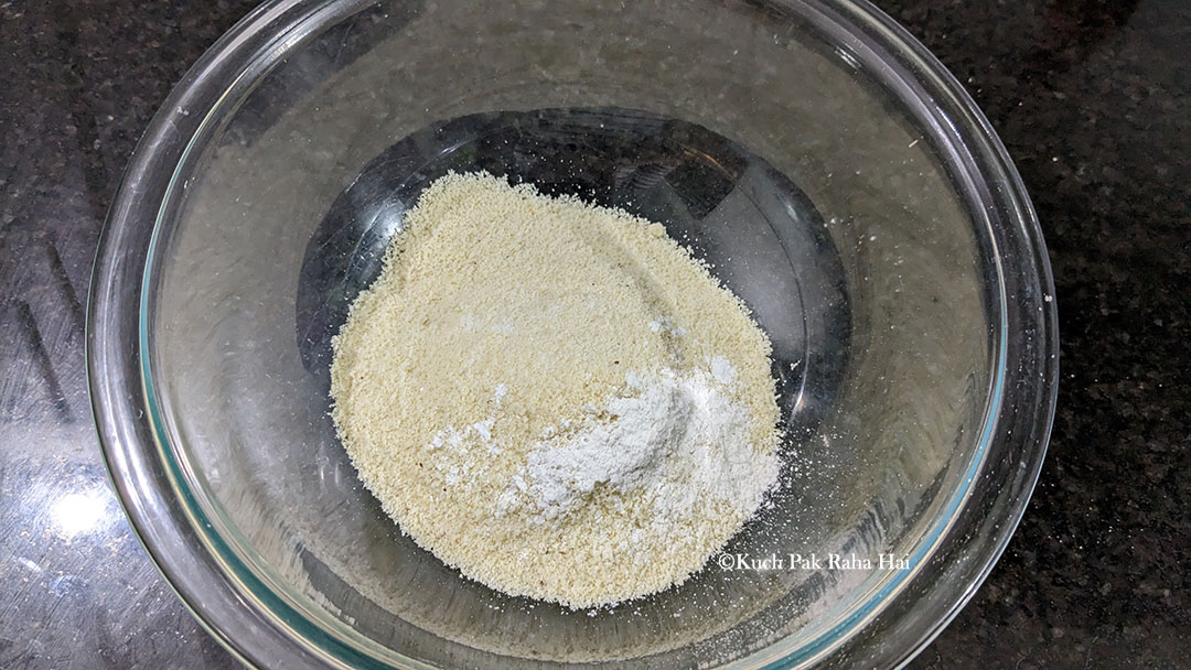 Mixing almond flour with baking powder and salt in a bowl.