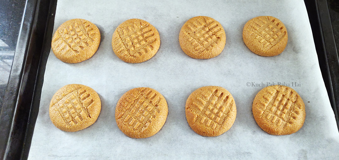 Baked  almond peanut cookies on baking tray.